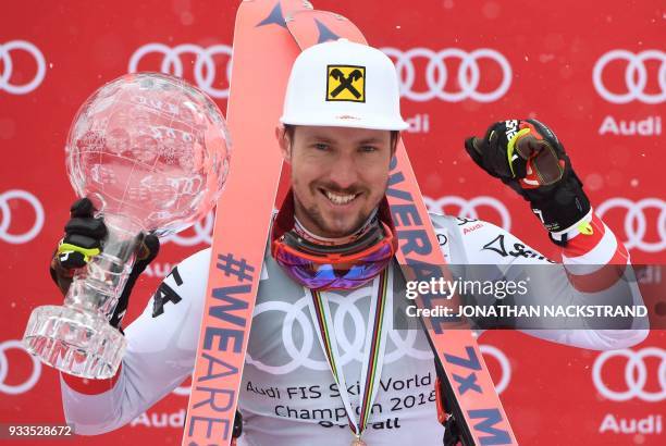 Overall Winner of the Men's Alpine Skiing World Cup Marcel Hirscher of Austria celebrates on the podium in Aare, Sweden, on March 18, 2018. / AFP...