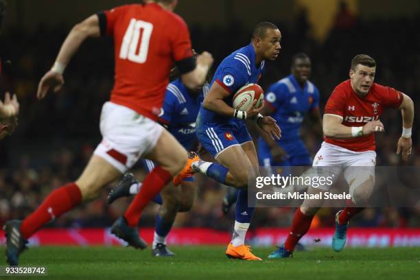 Gael Fickou of France bursts between Scott Williams and Dan Biggar of Wales to score his sides opening try during the NatWest Six Nations match...