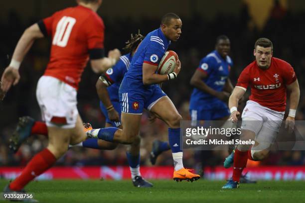 Gael Fickou of France bursts between Scott Williams and Dan Biggar of Wales to score his sides opening try during the NatWest Six Nations match...
