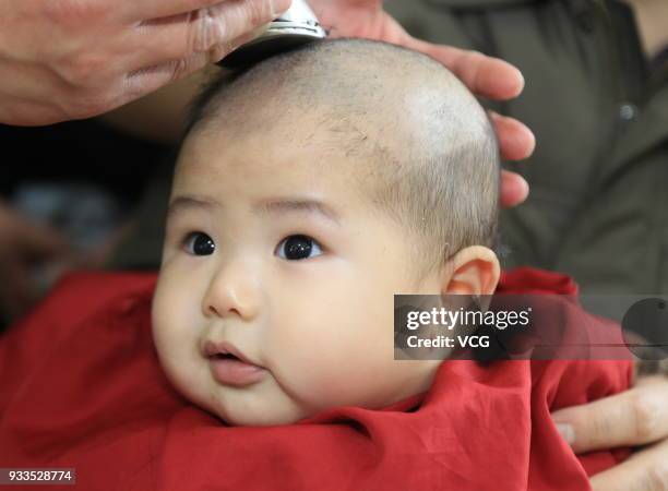 Boy gets a haircut on the Longtaitou Festival on March 18, 2018 in Huaian, Jiangsu Province of China. As a traditional custom, Chinese people get a...
