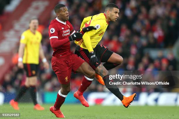 Georginio Wijnaldum of Liverpool collides with Etienne Capoue of Watford during the Premier League match between Liverpool and Watford at Anfield on...