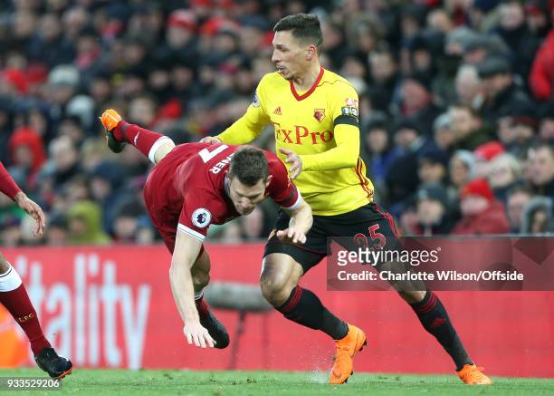 Jose Holebas of Watford pushes James Milner of Liverpool over during the Premier League match between Liverpool and Watford at Anfield on March 17,...