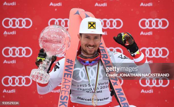 Overall Winner of the Men's Alpine Skiing World Cup Marcel Hirscher of Austria celebrates on the podium in Aare, Sweden, on March 18, 2018. / AFP...