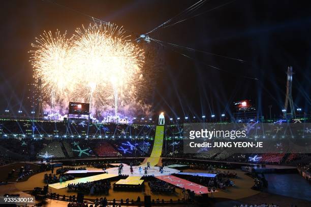 Fireworks erupt during the closing ceremony of the Pyeongchang 2018 Winter Paralympic Games at the Pyeongchang Stadium in Pyeongchang on March 18,...
