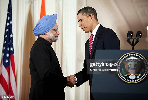 Manmohan Singh, India's prime minister, left, shakes hands with U.S. President Barack Obama during an arrival ceremony in the East Room of the White...