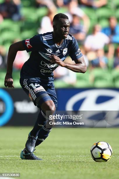 Thomas Deng of the Victory runs with the ball during the round 23 A-League match between the Melbourne Victory and the Central Coast Mariners at AAMI...