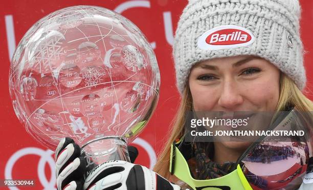 Overall Winner of the Women's Alpine Skiing World Cup Mikaela Shiffrin of the US holds the trophy as she celebrates on the podium in Aare, Sweden, on...