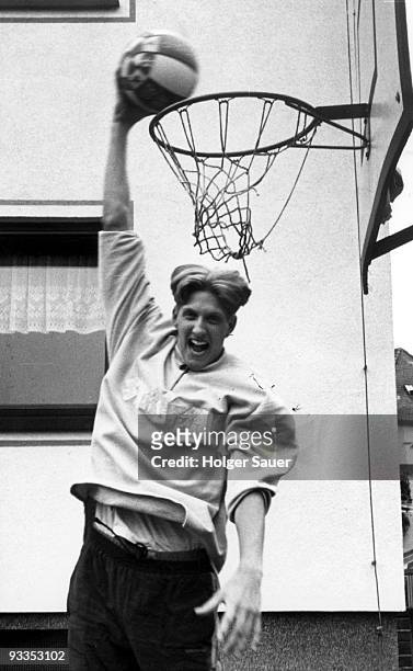 Dirk Nowitzki plays basketball in front of his parent's house on May 7, 1996 in Wuerzburg, Germany.