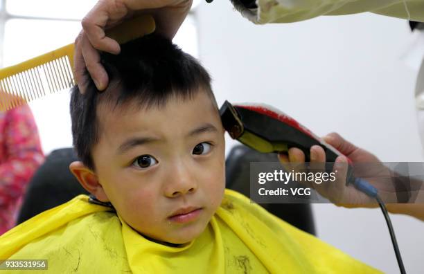 Boy gets a haircut on the Longtaitou Festival on March 18, 2018 in Lianyungang, Jiangsu Province of China. As a traditional custom, Chinese people...