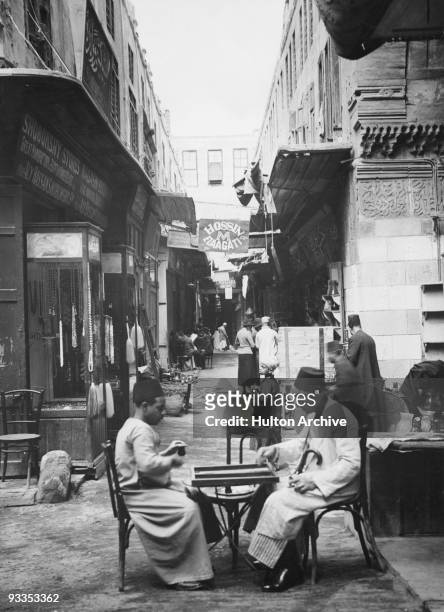 Two men at a board game in the Mouski Bazaar, Cairo, circa 1930.