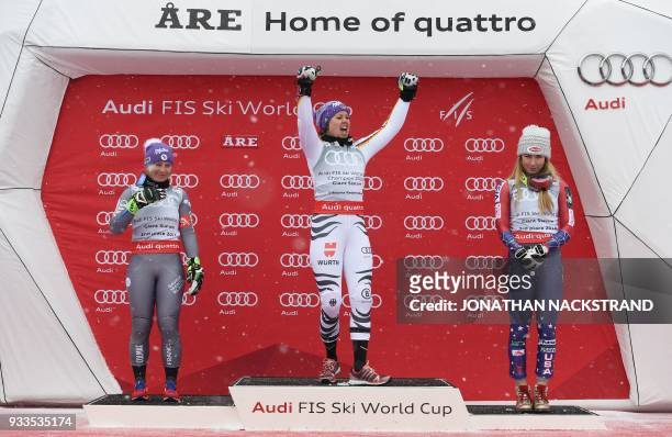 Overall winners of the Women's Giant Slalom discipline of the Alpine Skiing World Cup celebrate on the podium Tessa Worley of France, Viktoria...