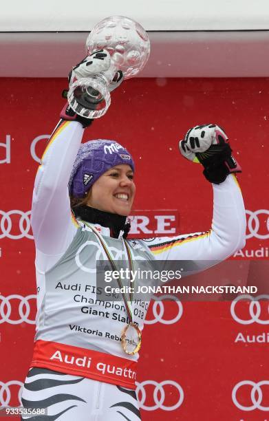 Overall winner of the Women's Giant Slalom discipline of the Alpine Skiing World Cup Viktoria Rebensburg of Germany celebrates on the podium in Aare,...