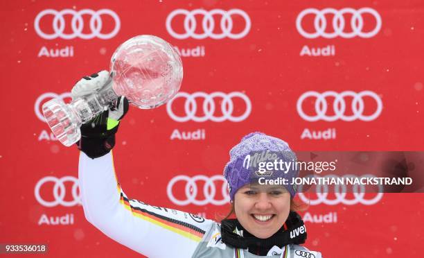 Overall winner of the Women's Giant Slalom discipline of the Alpine Skiing World Cup Viktoria Rebensburg of Germany celebrates on the podium in Aare,...