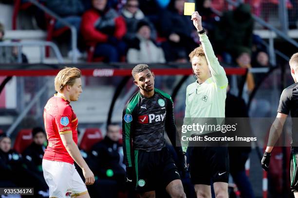 Juninho Bacuna of FC Groningen receives a yellow card from referee Martin van den Kerkhof during the Dutch Eredivisie match between AZ Alkmaar v FC...