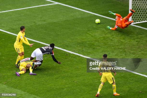 Nice's Italian forward Mario Balotelli fouls Paris Saint-Germain's French defender Presnel Kimpembe as he heads the ball against the post of Paris...