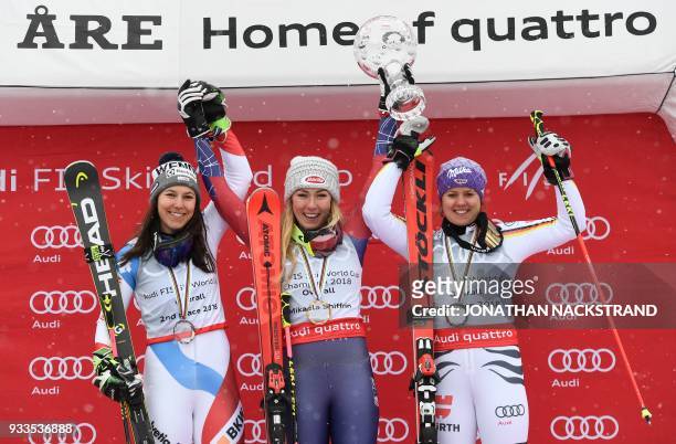 Overall winners of the Women's Alpine Skiing World Cup celebrate on the podium Wendy Holdener of Switzerland, Mikaela Shiffrin of the US and Viktoria...