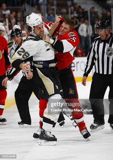 Eric Godard of the Pittsburgh Penguins fights with Chris Neil of the Ottawa Senators in a game at Scotiabank Place on November 19, 2009 in Ottawa,...