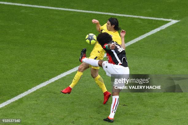 Nice's Brazilian defender Dante clears a ball under pressure from Paris Saint-Germain's Uruguayan forward Edinson Cavani during the French L1...