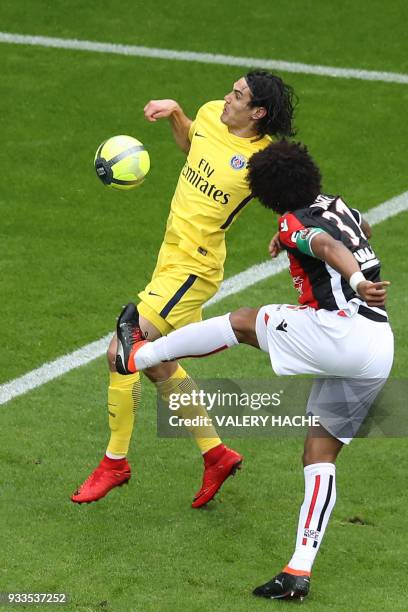 Nice's Brazilian defender Dante clears a ball under pressure from Paris Saint-Germain's Uruguayan forward Edinson Cavani during the French L1...