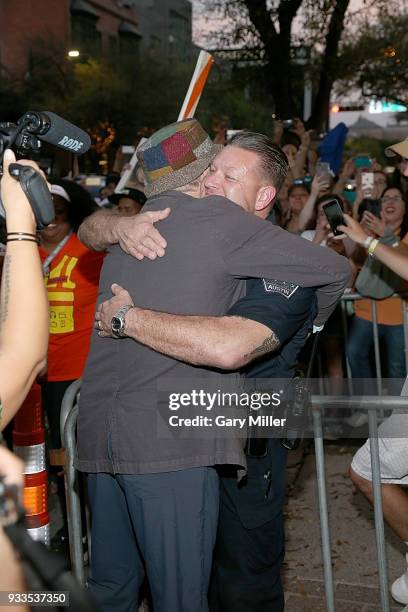 Bill Murray jokes with an Austin Police Department officer at the premiere of "Isle of Dogs" at the Paramount Theatre during South By Southwest on...