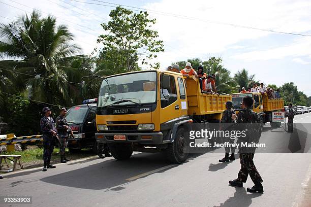 Philippine soldiers inspect vehicle along the highway following the massacre of at least 46 people, including the wife, sister and other relatives of...