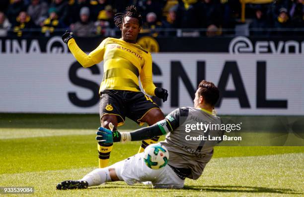 Michy Batshuayi of Dortmund is challenged by Philipp Tschauner of Hannover during the Bundesliga match between Borussia Dortmund and Hannover 96 at...