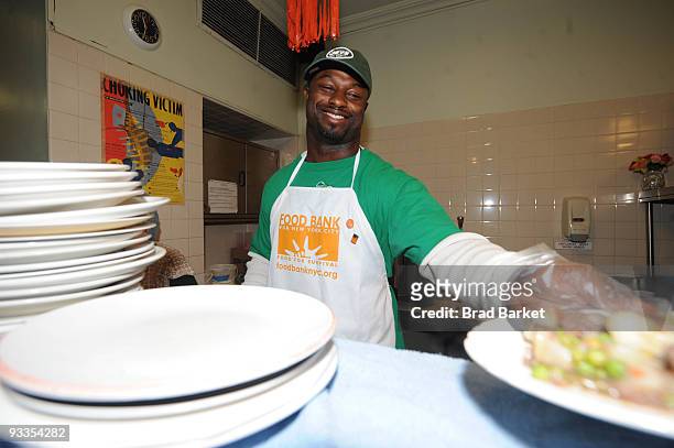 Bart Scott of the New York Jets serves lunch at the Food Bank For New York City at "CHIPS" Park Slope Christian Help on November 24, 2009 in New York...