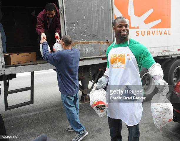 Bart Scott of the New York Jets unloads turkeys for the Food Bank For New York City at "CHIPS" Park Slope Christian Help on November 24, 2009 in New...