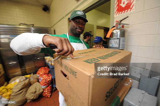 Bart Scott of the New York Jets unpacks vegetables at the Food Bank For New York City at "CHIPS" Park Slope Christian Help on November 24, 2009 in...