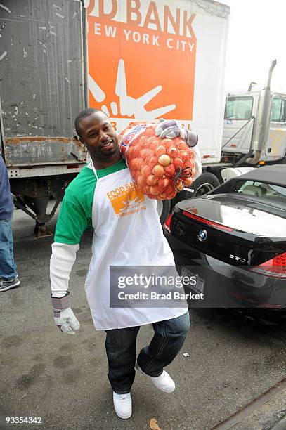 Bart Scott of the New York Jets unloads food for the Food Bank For New York City at "CHIPS" Park Slope Christian Help on November 24, 2009 in New...