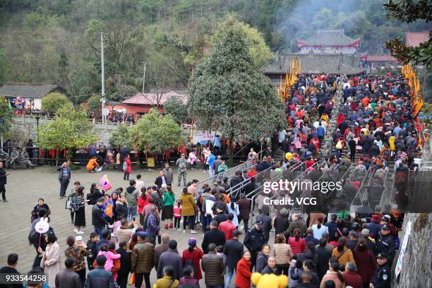 People attend 'treading on bridge' fair to pray for blessing at Jushui Town on March 17, 2018 in Mianyang, Sichuan Province of China. As a...