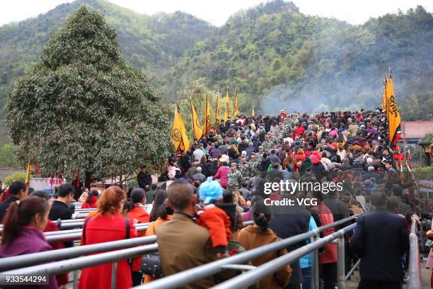 People attend 'treading on bridge' fair to pray for blessing at Jushui Town on March 17, 2018 in Mianyang, Sichuan Province of China. As a...
