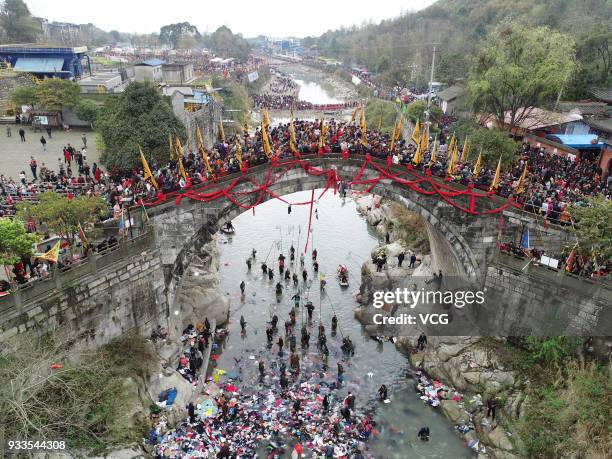 People attend 'treading on bridge' fair to pray for blessing at Jushui Town on March 17, 2018 in Mianyang, Sichuan Province of China. As a...