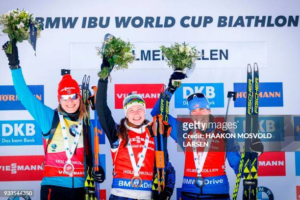 Anastasiya Kuzmina from Slovakia, winner Darya Domracheva from Belarus and Susan Dunklee from the US celebrate on the podium after the IBU Biathlon...
