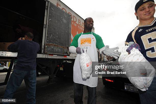 Bart Scott of the New York Jets unloads turkeys for the Food Bank For New York City at "CHIPS" Park Slope Christian Help on November 24, 2009 in New...