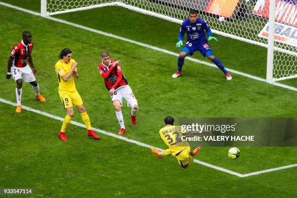 Paris Saint-Germain's Brazilian defender Daniel Alves shoots on goal as Nice's French defender Malang Sarr, Paris Saint-Germain's Uruguayan forward...