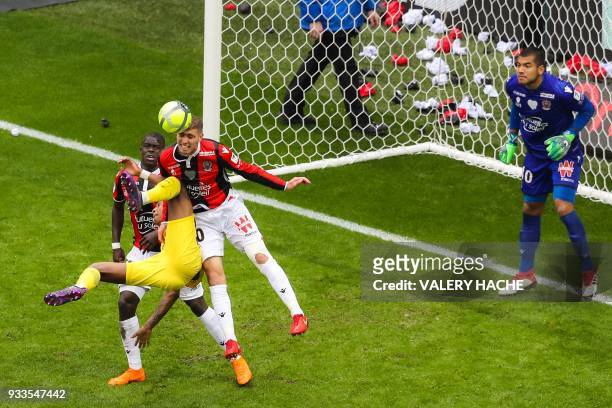 Nice's French defender Malang Sarr, Paris Saint-Germain's French defender Presnel Kimpembe and Nice's French defender Maxime Le Marchand go for the...