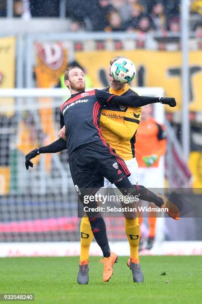 Moritz Hartmann of Ingolstadt and Sascha Horvath of Dresden jump for a header during the Second Bundesliga match between FC Ingolstadt 04 and SG...