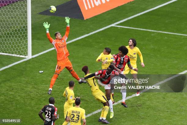 Paris Saint-Germain's French goalkeeper Alphonse Areola jumps to deflect a header from Nice's Italian forward Mario Balotelli during the French L1...