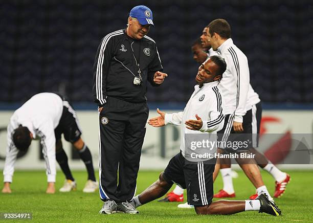 Manager Carlo Ancelotti speaks to Didier Drogba during the Chelsea training session, prior to UEFA Champions League Group D match against FC Porto,...
