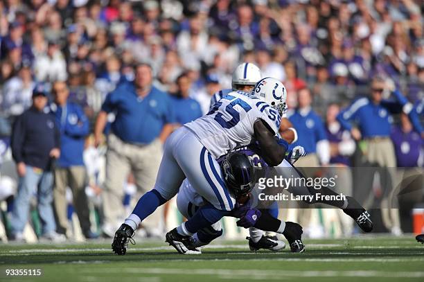 Clint Session of the Indianapolis Colts tackles Willis McGahee of the Baltimore Ravens at M&T Bank Stadium on November 22, 2009 in Baltimore,...