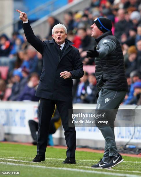 Mark Hughes manager of Southampton and Paul Cook manager of Wigan Athletic gives instructions from the touchline during The Emirates FA Cup Quarter...