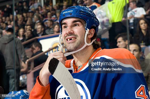 Zack Stortini of the Edmonton Oilers adjusts his chin strap from the bench during a game against the New York Rangers at Rexall Place on November 5,...