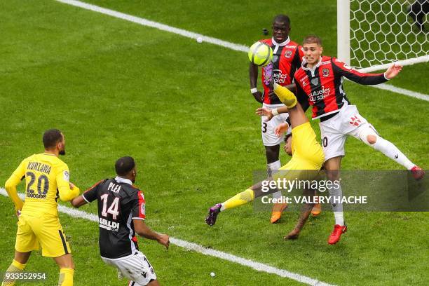 Nice's French defender Maxime Le Marchand, Paris Saint-Germain's French defender Presnel Kimpembe and Nice's French defender Malang Sarr go for the...