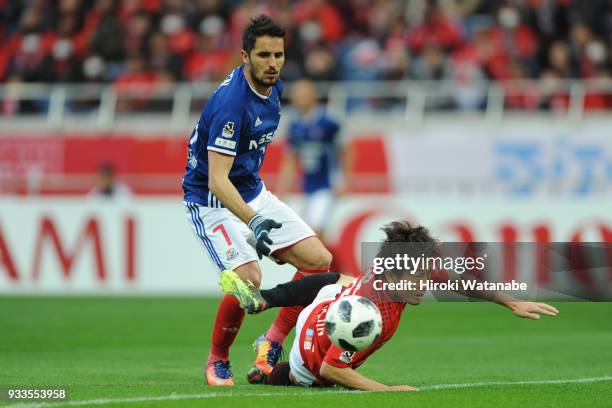 Hugo Vieira of Yokohama F.Marinos and Tomoya Ugajin of Urawa Red Diamonds compete for the ball during the J.League J1 match between Urawa Red...