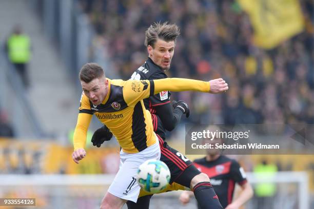 Haris Duljevic of Dresden and Stefan Kutschke of Ingolstadt jump for a deader during the Second Bundesliga match between FC Ingolstadt 04 and SG...