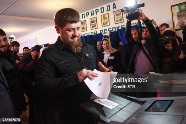 Chechnya's leader Ramzan Kadyrov casts his ballot as he votes during Russia's presidential election at a polling station in the settlement of...