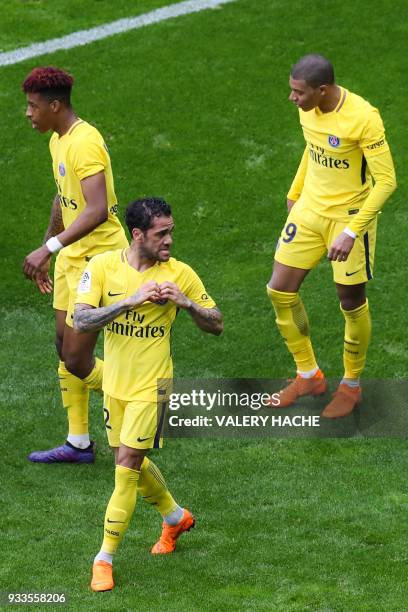 Paris Saint-Germain's Brazilian defender Dani Alves celebrates with Paris Saint-Germain's French defender Presnel Kimpembe and Paris Saint-Germain's...