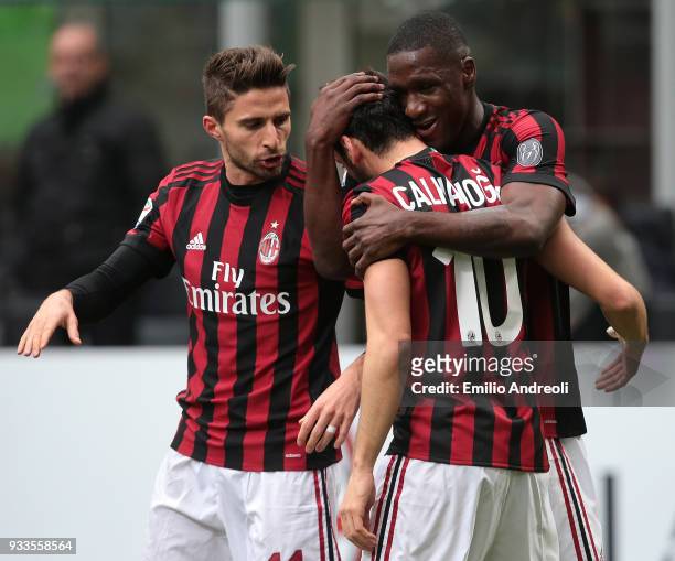 Hakan Calhanoglu of AC Milan celebrates with his team-mates Cristian Zapata and Fabio Borini after scoring the opening goal during the serie A match...