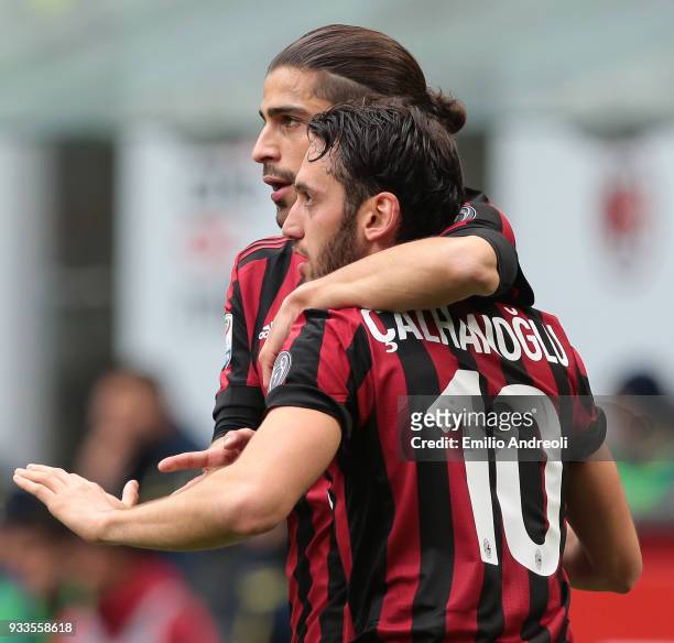 Hakan Calhanoglu of AC Milan celebrates with his team-mate Ricardo Rodriguez after scoring the opening goal during the serie A match between AC Milan...